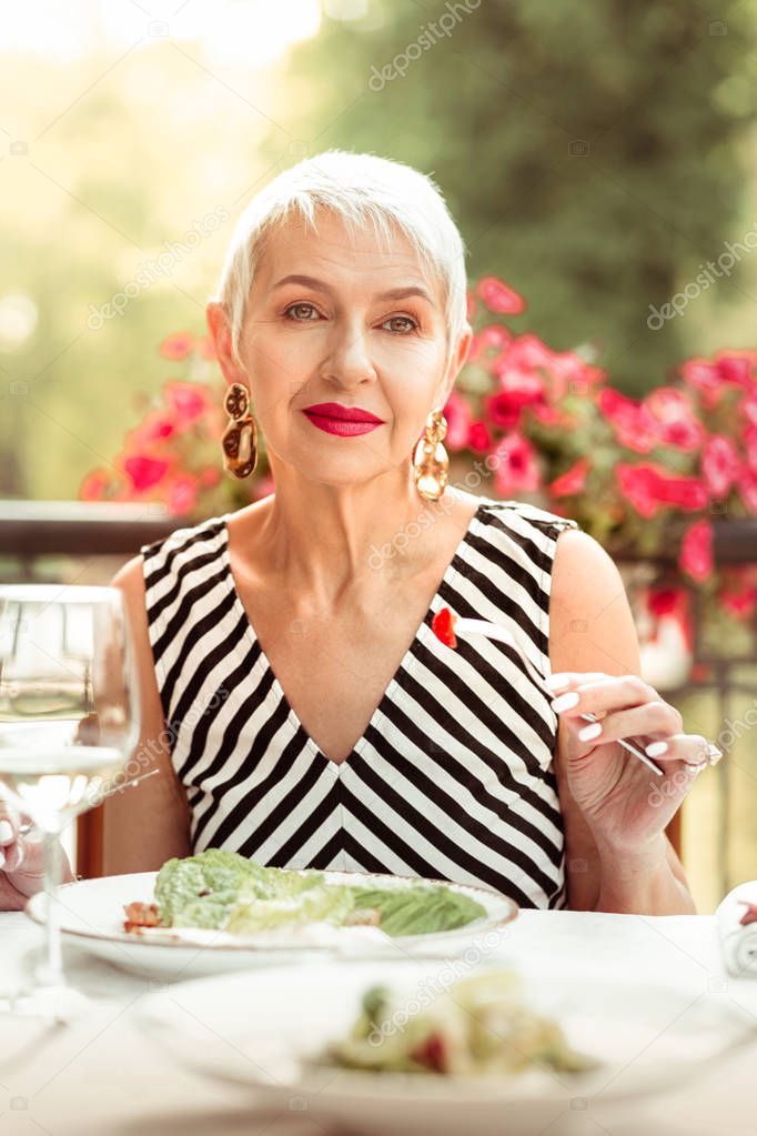 Mature woman wearing dress having romantic dinner outside