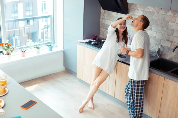 Woman sharing sweet cherry with her handsome man — Stock Photo, Image