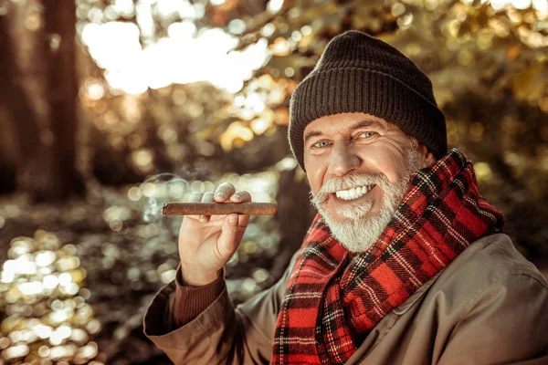 Bearded senior man going to smoke a cigar. — Stock Photo, Image