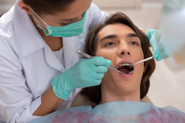 Morena bien parecido adolescente acostado en una silla de dentistas —  Fotos de Stock