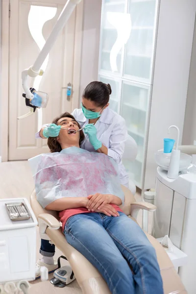 Uważna kobieta lekarz bada młodych pacjentów usta — Zdjęcie stockowe