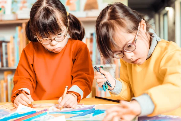 Dark-haired children with health problem being concentrated on an art creating — Stock Photo, Image