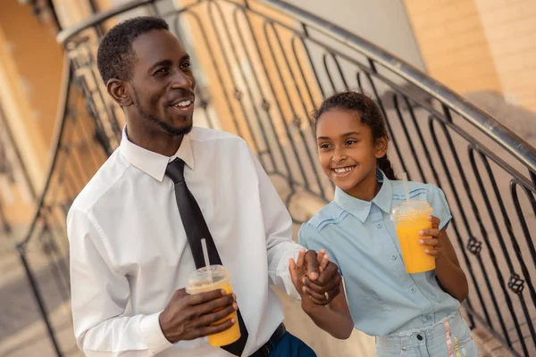 Handsome man walking hand in hand with his kid — Stock Photo, Image