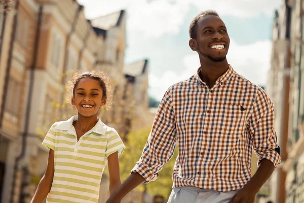 Happy dark-skinned male person enjoying family weekend — Stock Photo, Image