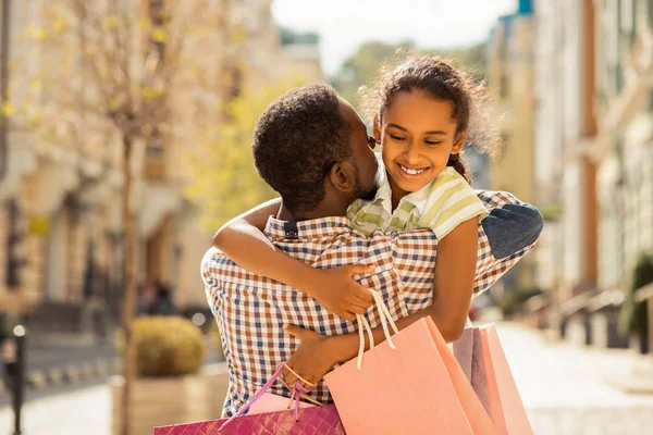 Positive delighted teenager embracing her young dad — Stock Photo, Image