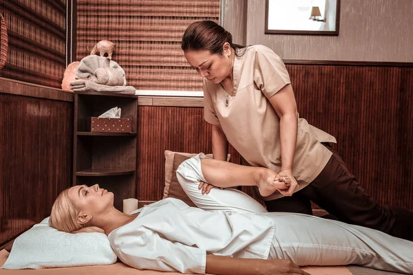 Relajada mujer consiguiendo su tailandés masaje sesión . — Foto de Stock