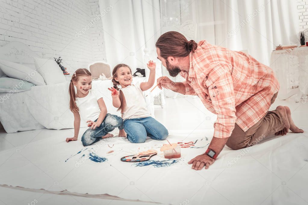 Smiling and happy kids drawing with their dad