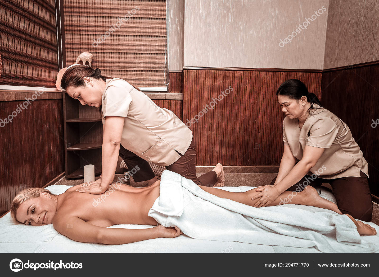 Smiling getting special four-hand massage. Stock by ©yacobchuk1 294771770