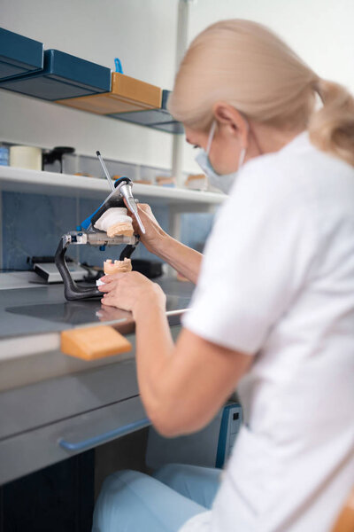 Dental technician making dental prosthesis for the patient.