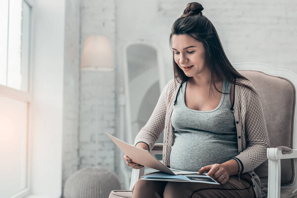 Beautiful brunette girl spending time in cozy atmosphere