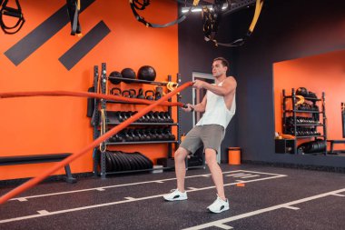 Yakışıklı güçlü adam özel halatlar ile egzersiz