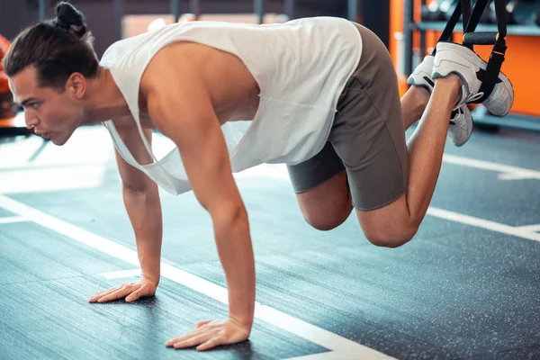 Inteligente guapo hombre entrenamiento en trx correas — Foto de Stock