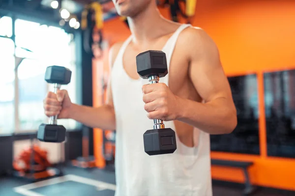 Selective focus of a dumbbell in male hands — Stock Photo, Image