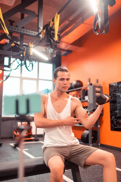 Serious fit man having a tutorial online — Stock Photo, Image