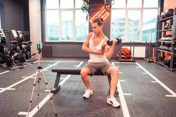 Guapo joven mostrando cómo entrenar —  Fotos de Stock