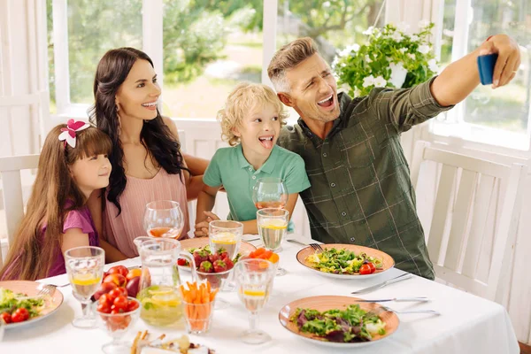 Famiglia che fa selfie mentre pranza in casa estiva — Foto Stock