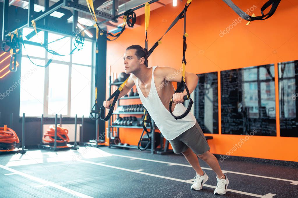 Handsome athletic man training during the workout