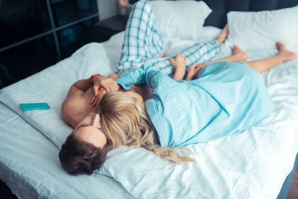 Couple chilling and sleeping together on big bed — Stock Photo, Image