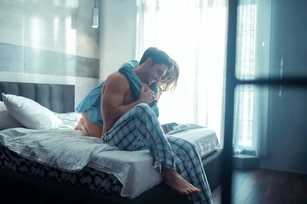 Junges Paar umarmt sich, während es den Morgen zusammen verbringt — Stockfoto