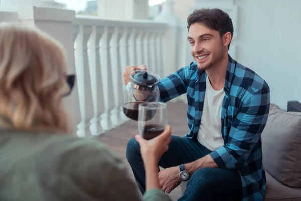 Man glimlachend en gieten koffie voor vrouw — Stockfoto