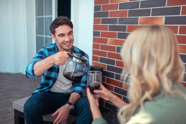 Husband smiling while pouring coffee for his blonde wife — Stock Image Husband smiling while pouring coffee for his blonde wife Stock Picture