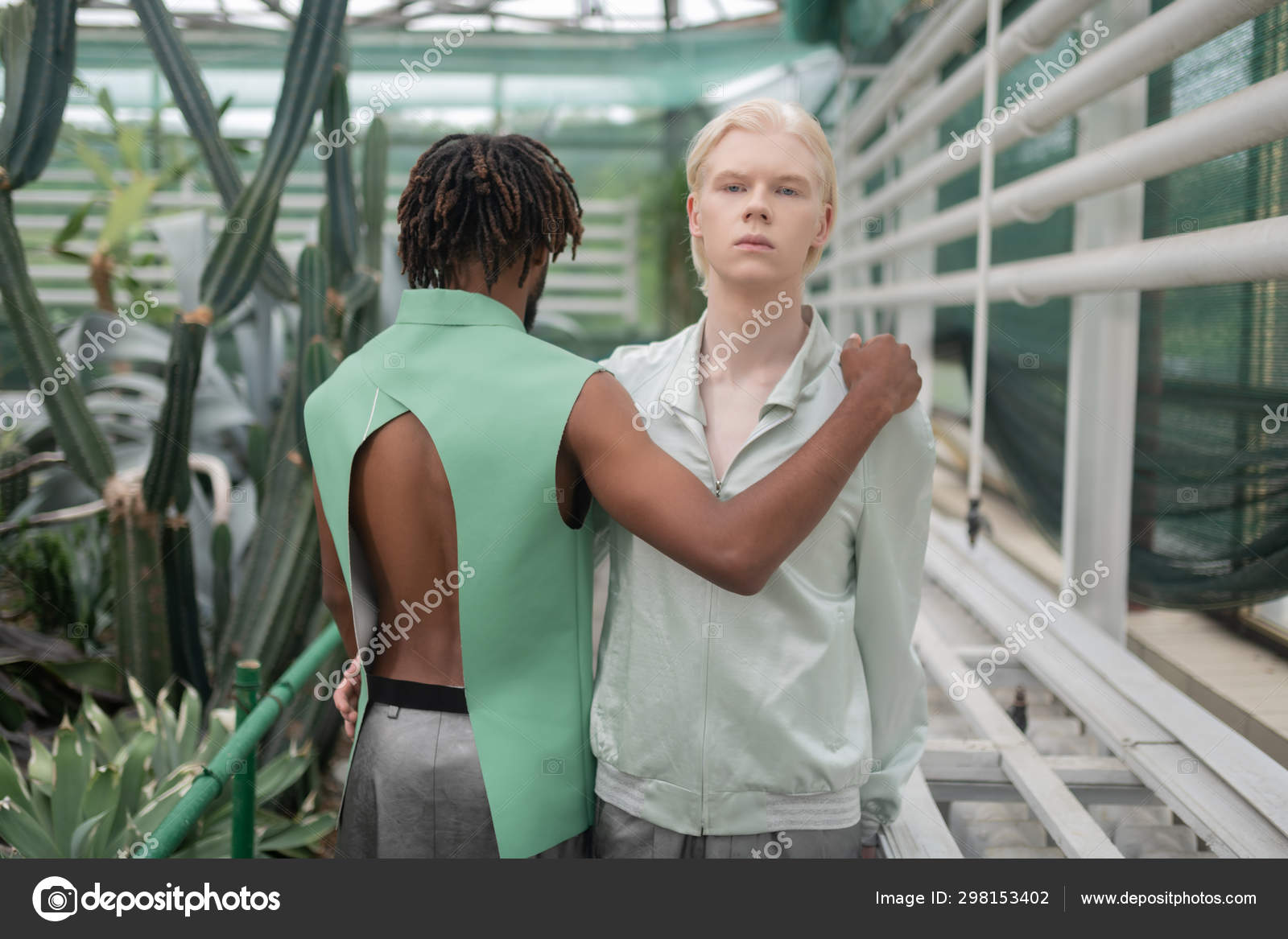 African American Man With Dreadlocks Hugging Blonde Man