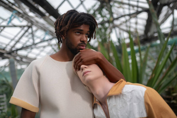 Dark-skinned model posing with his light-skinned colleague