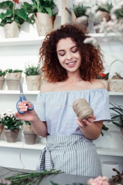 Makas ve ip taşıyan kırmızı saçlı çekici kadın Işınlama