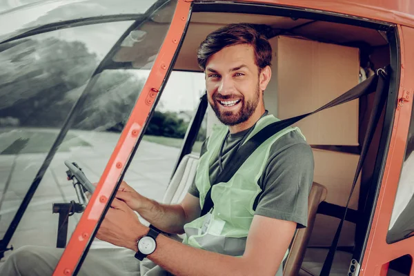 Handsome professional pilot sitting in little private helicopter — Stock Photo, Image