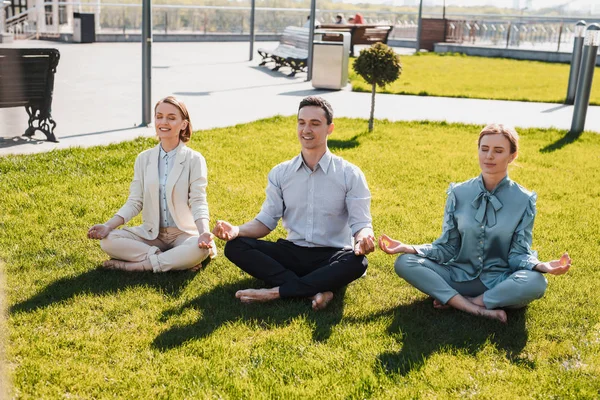 People restoring their energy meditating in the park