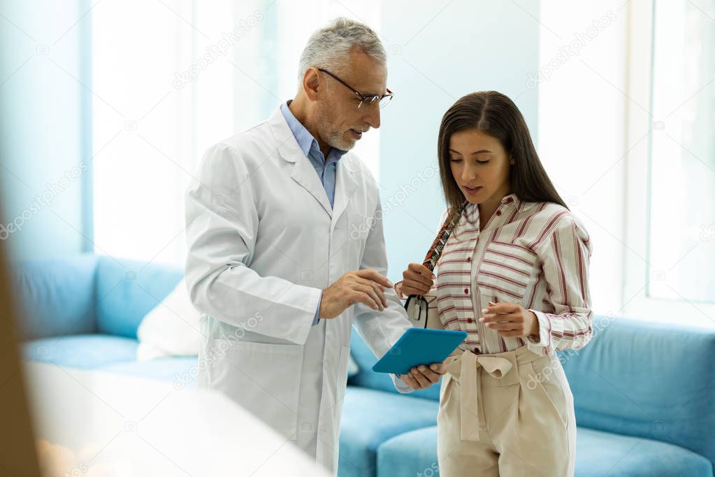Attentive brunette girl listening to her practitioner