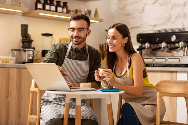 Empresários bebendo café e assistindo vídeo no laptop — Fotografia de Stock