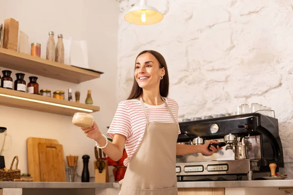 Przyjemny Barista uśmiechnięty dając kawę do klienta — Zdjęcie stockowe