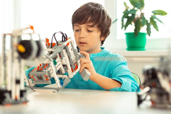 Schoolboy working with construction set at the lesson. — Stock Photo, Image