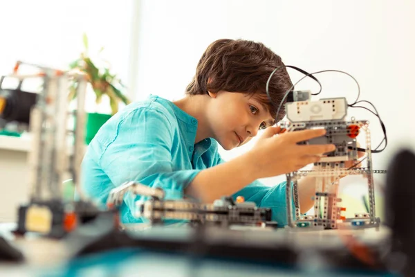 Enthusiastic pupil fixing the robot at science lesson. — Stock Photo, Image