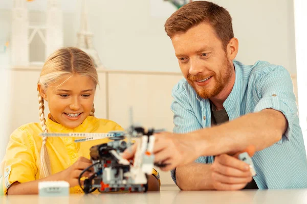 Teacher showing his pupil model of helicopter in work. — Stock Photo, Image