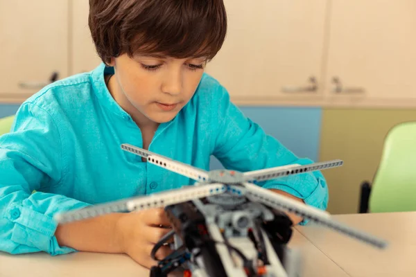 Serious schoolboy working on his helicopter model. — Stock Photo, Image