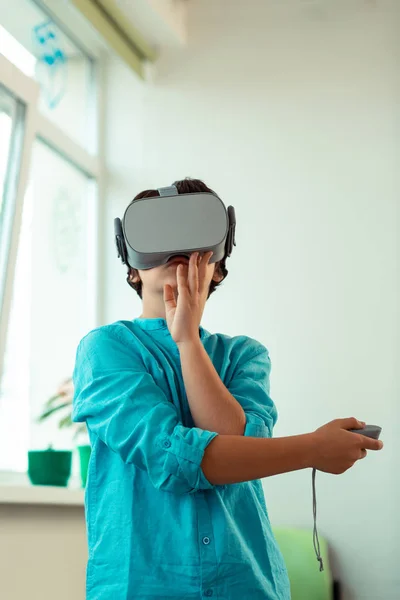 Pupil playing virtual games at school lesson