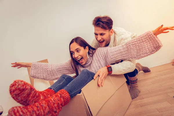 Young people kidding around during their moving — Stock Photo, Image