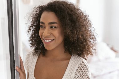 Mutlu genç bir kadın samimi gülümsemesini gösteriyor.