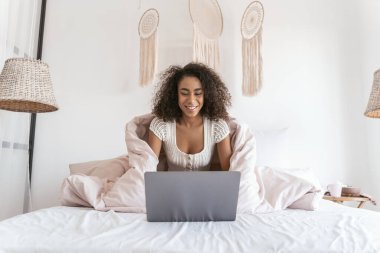 Evinde film izleyen uluslararası genç bayan.