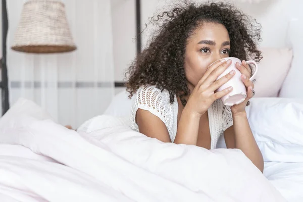 Pleased brunette female being deep in thoughts — Stock Photo, Image