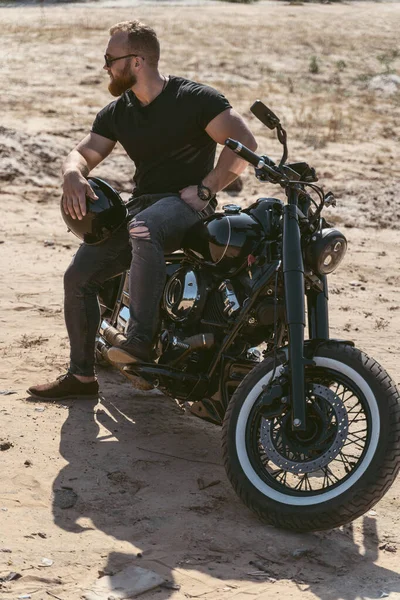 Bonito barbudo sentado em sua moto — Fotografia de Stock