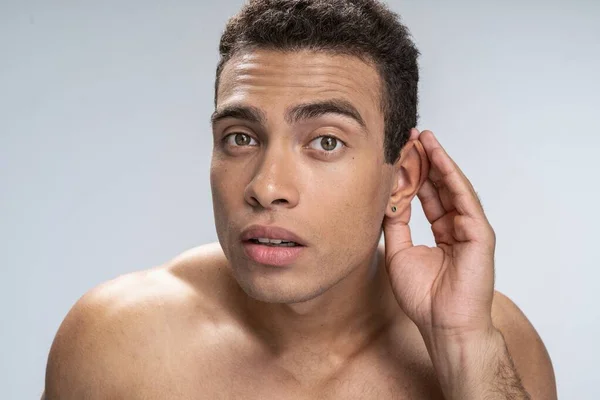 Handsome young man trying to hear something — Stock Photo, Image