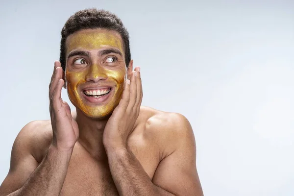 Handsome man cheering about his new skin care — Stock Photo, Image