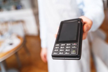 Bağlantı kurulamayan ödeme için terminali tutan genç adam.