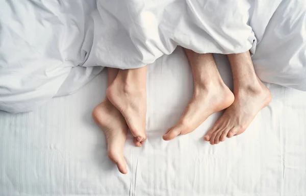 Женщина и мужчина под одеялом — стоковое фото