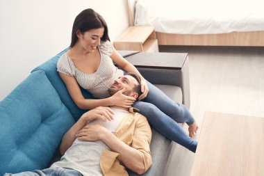 Güzel yeni evliler evde birlikte dinleniyor ve dinleniyorlar.