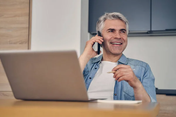 Grey-haired male sitting in the kitchen indoors — Stock Photo, Image