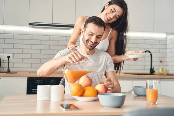 Szczęśliwa młoda para cieszy się śniadaniem w domu — Zdjęcie stockowe